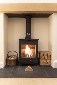 Log burning stove set up with briquettes